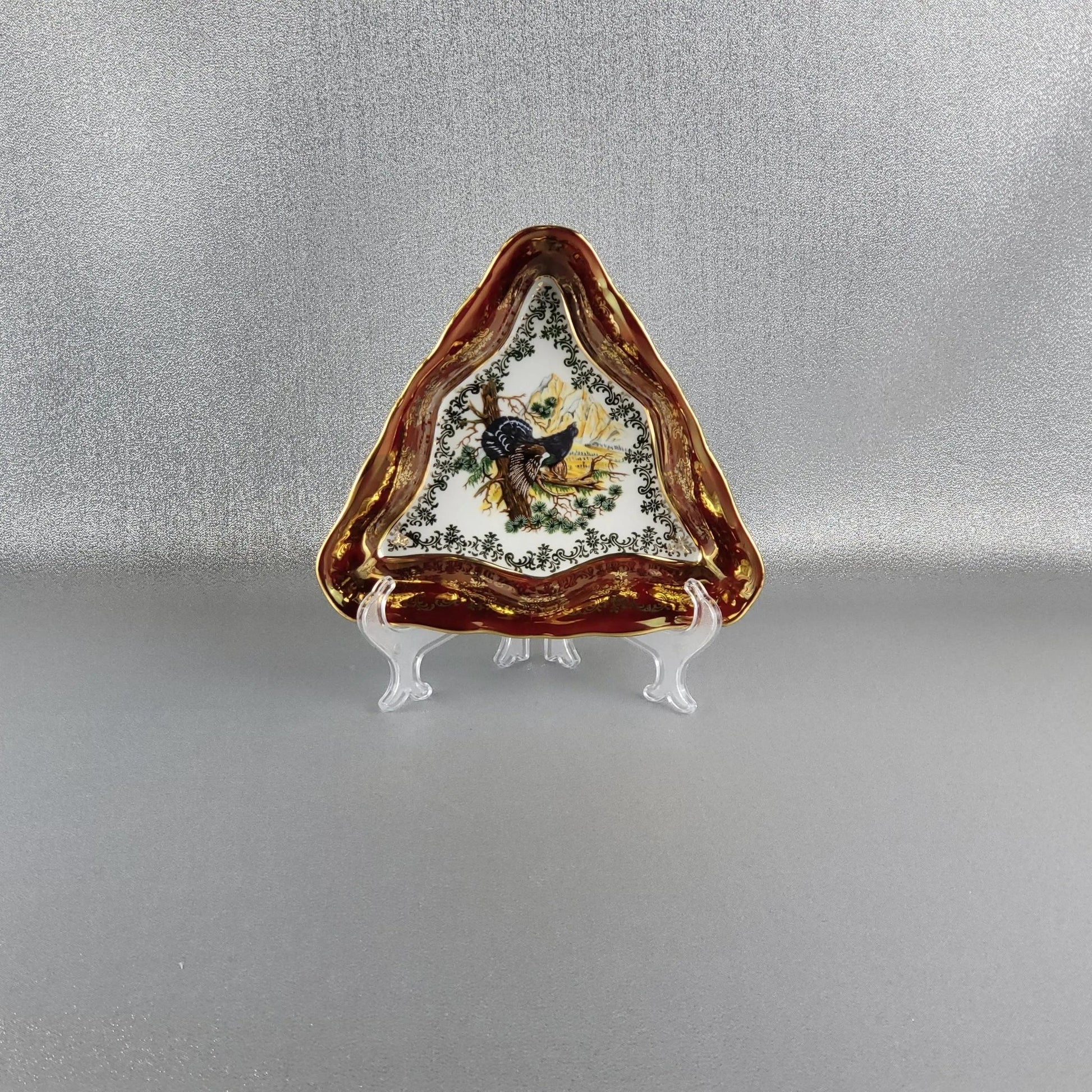 The porcelain serving triangle bowl, "Hunting" (Blackcock bird) in red by Queens Crown. Size 20 cm.