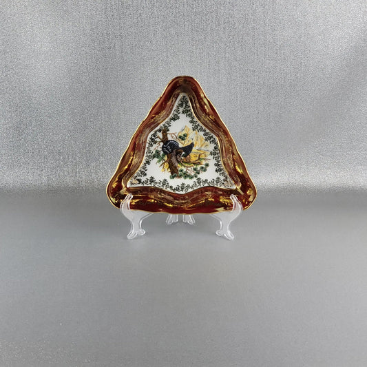 The porcelain serving triangle bowl, "Hunting" (Blackcock bird) in red by Queens Crown. Size 20 cm.